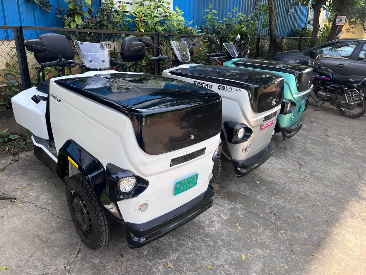 Three CROC EVs parked together in a yard, photographed